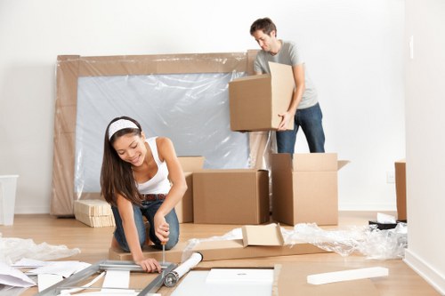 Removal staff using safe manual handling practices during a move