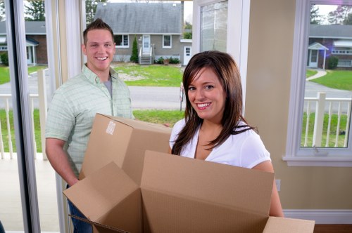 Professional movers handling furniture in a Highbury flat